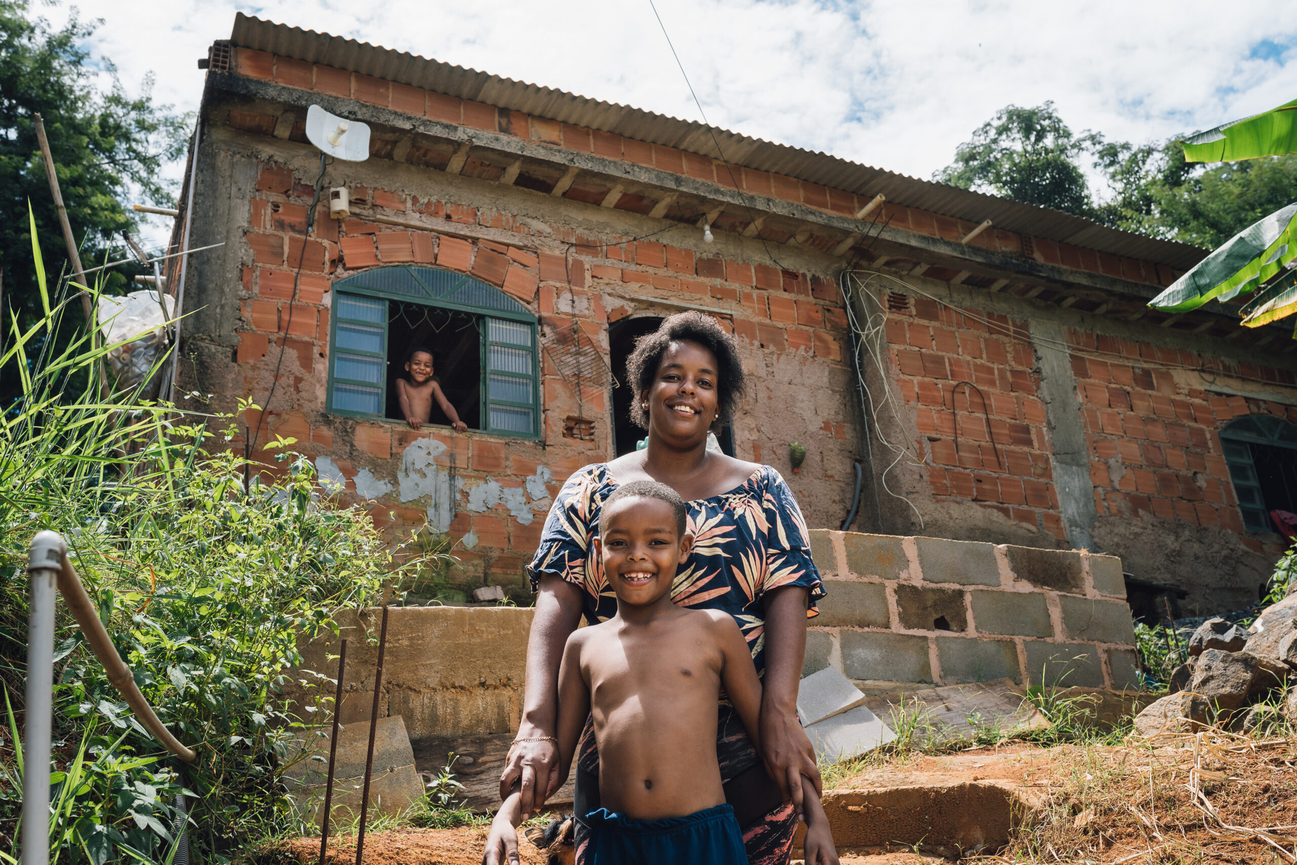 Mother and children in front of the house